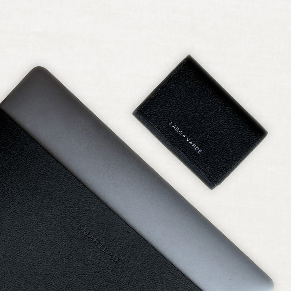 Labovarde Business Card Holder in Black — Flat lay view showing engraving logo detail and Laptop Sleeve in Black on a white background