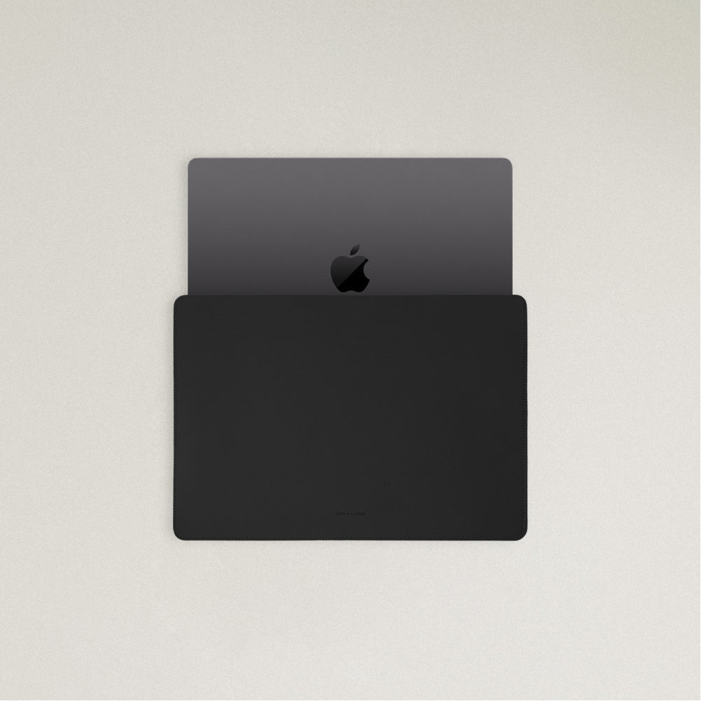 Labovarde Laptop Sleeve in Black — Top view with a space gray MacBook partially inserted to show the sleek fit