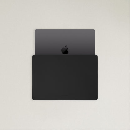 Labovarde Laptop Sleeve in Black — Top view with a space gray MacBook partially inserted to show the sleek fit