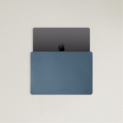 Labovarde Laptop Sleeve in Pale Blue — Top view with a space gray MacBook partially inserted to show the sleek fit