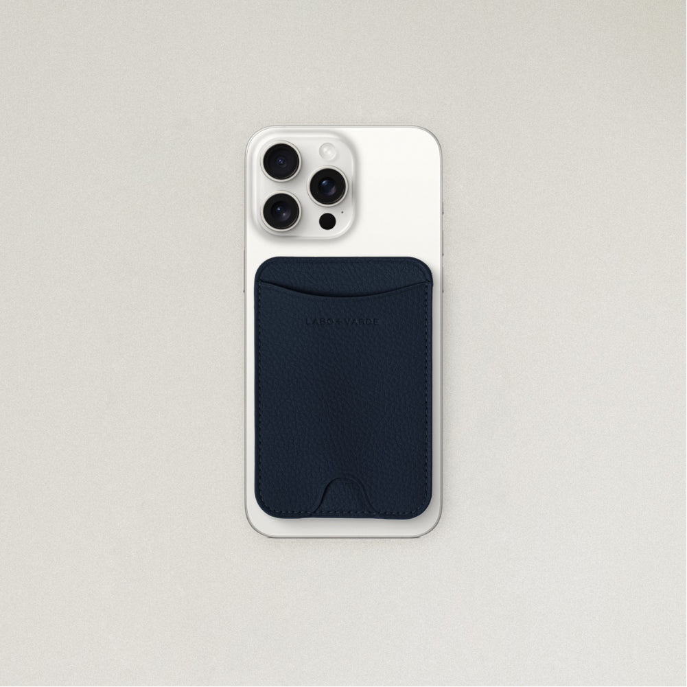 Labovarde MagSafe Card Wallet in Navy — Attached to a white iPhone, showing the magenetic fit and debossed logo