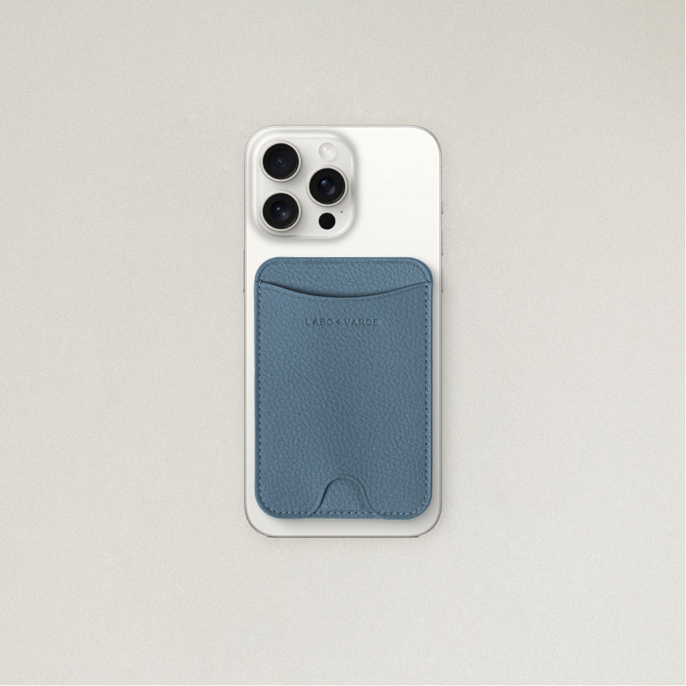 Labovarde MagSafe Card Wallet in pale-blue — Attached to a white iPhone, showing the magenetic fit and debossed logo